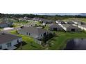 A beautiful aerial view of a planned community with well-maintained lawns, sidewalks, and serene pond views at 3919 Willowbrook Dr, Edgewater, FL 32141