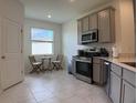 Eat-in kitchen featuring stainless steel appliances, ample natural light, and seating area with table and chairs at 3919 Willowbrook Dr, Edgewater, FL 32141