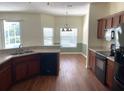 Well-equipped kitchen with stainless steel appliances, wood cabinets and breakfast bar overlooking the dining area at 405 Central Mariners Dr, Edgewater, FL 32141