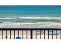 Relaxing ocean view from the balcony of this condo, with a sandy beach and gentle waves at 4141 S Atlantic Ave # 605, New Smyrna Beach, FL 32169
