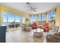 Bright and spacious living room with tile flooring, comfortable seating, and panoramic water views at 438 Bouchelle Dr # 105, New Smyrna Beach, FL 32169