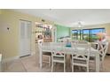 Bright dining area with white table and chairs, adjacent to a living space at 454 Bouchelle Dr # 102, New Smyrna Beach, FL 32169