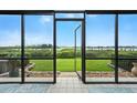 Enjoy outdoor living with a screened-in patio overlooking the lush green yard at 454 Bouchelle Dr # 102, New Smyrna Beach, FL 32169