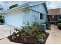 Exterior of home featuring a well-kept lawn, tidy landscaping, and a neutral paint scheme at 51 Fore Dr, New Smyrna Beach, FL 32168