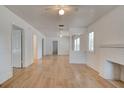 Spacious open-plan living room featuring white walls, hardwood floors, and abundant natural light at 514 Mary Ave, New Smyrna Beach, FL 32168