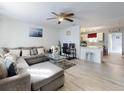 Open-concept living room with modern finishes, wood-look flooring, and plenty of natural light at 5476 W Bayshore Dr, Port Orange, FL 32127