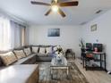 Bright living room featuring a comfortable gray sectional and stylish decor at 5476 W Bayshore Dr, Port Orange, FL 32127