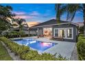 A backyard with a pristine pool surrounded by lush greenery, ideal for relaxation at 6294 W Fallsgrove Ln, Port Orange, FL 32128