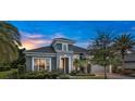 Stunning home featuring stone accents, a well-manicured lawn, and a spacious garage at 6294 W Fallsgrove Ln, Port Orange, FL 32128