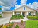 Single-Gathering home featuring a well-kept lawn, a two-car garage, and a welcoming front entrance at 6804 Forkmead Ln, Port Orange, FL 32128