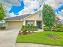 Charming single-story home with a tidy lawn, an attached garage, and tastefully trimmed hedges at 6804 Forkmead Ln, Port Orange, FL 32128