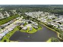 Serene aerial view of the neighborhood showcasing homes backing onto a lake at 684 Rochester Ct, New Smyrna Beach, FL 32168