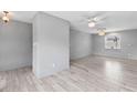 Spacious living area features tile floors, neutral paint, ceiling fan, and bright natural light at 800 Black Duck Dr, Port Orange, FL 32127