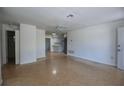 Bright living room featuring terrazzo flooring and an open layout leading to the kitchen at 805 E 18Th Ave, New Smyrna Beach, FL 32169