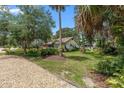 View of the home's exterior showing its landscaped front yard and gravel driveway at 807 Craig St, New Smyrna Beach, FL 32168