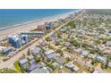 Aerial view of a coastal neighborhood showing proximity to the beach and surrounding properties at 821 Ocean Ave, New Smyrna Beach, FL 32169