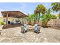 Beautiful backyard featuring a stone fire pit area and covered patio perfect for outdoor relaxation at 821 Ocean Ave, New Smyrna Beach, FL 32169