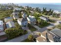 Aerial view of coastal home with tropical landscaping near the ocean, offering scenic beachfront living at 895 Catfish Ave, New Smyrna Beach, FL 32169
