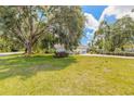 Spacious front yard showcases mature trees and meticulous landscaping enhancing the property's curb appeal at 904 Clubhouse Blvd, New Smyrna Beach, FL 32168