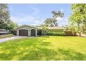 A beautiful green home with a well-kept lawn, a two-car garage, and a charming entrance, showcasing curb appeal at 154 Godfrey Rd, Edgewater, FL 32141