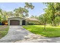 Lovely one story home with a garage, an extended driveway, and a luscious lawn, perfect for a Gathering seeking comfort at 154 Godfrey Rd, Edgewater, FL 32141