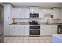 Bright kitchen with stainless steel appliances, white cabinets, and light countertops at 101 N Riverside Dr # 1090, New Smyrna Beach, FL 32168