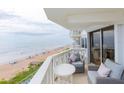 Balcony with seating overlooks the beach and ocean at 1051 Ocean Shore Blvd # 502, Ormond Beach, FL 32176