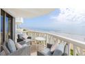 An outdoor balcony features comfortable seating and offers stunning views of the beach and ocean at 1051 Ocean Shore Blvd # 502, Ormond Beach, FL 32176