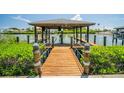 A covered boat dock offers waterfront access and includes a boat lift and seating at 1212 S Riverside Dr, New Smyrna Beach, FL 32168