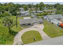 Aerial view of a home showcasing its compact layout and lawn at 2416 Pine Tree Dr, Edgewater, FL 32141