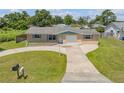 Charming home with a well-maintained lawn, featuring a tidy driveway and inviting curb appeal at 2416 Pine Tree Dr, Edgewater, FL 32141