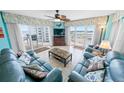 Cozy living room with ocean views, comfortable seating, and access to the balcony at 2967 S Atlantic Ave # 508, Daytona Beach, FL 32118