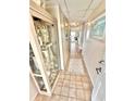 Hallway with tile flooring and decorated display case at 30 Inlet Harbor Rd # 606, Ponce Inlet, FL 32127