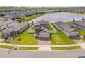Aerial view of a home with a pond in a residential neighborhood at 3116 Crab Trap Dr, New Smyrna Beach, FL 32168