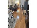 Hardwood floors leading into the living room with a large window letting in natural light at 3552 Casalta Cir, New Smyrna Beach, FL 32168