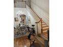 Open floorplan showcasing staircase with chandelier and dining table at 3552 Casalta Cir, New Smyrna Beach, FL 32168