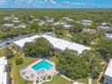 A picturesque aerial shot of a condo community featuring a pool and lush landscaping at 3800 Saxon Dr # 180, New Smyrna Beach, FL 32169