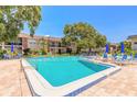 A pristine community pool with lounge chairs offering a relaxing outdoor space at 3800 Saxon Dr # 180, New Smyrna Beach, FL 32169