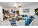 Bright living room featuring a comfortable sofa, stylish rug, decor, and ample natural light at 4150 S Atlantic Ave # 111B, New Smyrna Beach, FL 32169