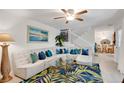 Stylish living room showcasing a large sectional sofa, decorative pillows, a unique rug, and a staircase at 4150 S Atlantic Ave # 111B, New Smyrna Beach, FL 32169