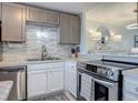 Modern kitchen with stainless steel appliances and a stylish backsplash at 4155 S Atlantic Ave # 111, New Smyrna Beach, FL 32169