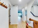 Bright hallway features wood floors, and a view into the main living area at 454 Bouchelle Dr # 202, New Smyrna Beach, FL 32169