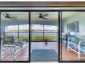 Enjoy water views from this tiled patio with chairs, table and ceiling fans at 454 Bouchelle Dr # 202, New Smyrna Beach, FL 32169