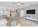 Bright living room featuring dining area, bar seating, and neutral decor for a cozy atmosphere at 5300 S Atlantic Ave # 5-502, New Smyrna Beach, FL 32169