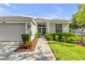 Welcoming home entrance with a charming blue door, manicured landscaping, and a well-maintained exterior at 5849 Ansley Way, Mount Dora, FL 32757