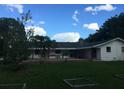 Back exterior view of home with patio and garden at 4500 S Hiawassee Rd, Orlando, FL 32835