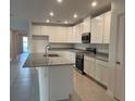 Modern kitchen featuring granite countertops, stainless steel appliances, and a spacious island at 515 Ingleside Ln, Haines City, FL 33844