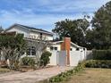 Two-story house with a brick chimney and fenced yard at 3115 Albert St, Orlando, FL 32806