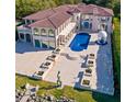 Aerial view of luxurious estate showcasing manicured grounds, long pool, and covered gazebo at 4852 S Peninsula Dr, Ponce Inlet, FL 32127