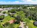 Aerial view of home with large, grassy yard and mature trees at 966 N Ronald Reagan Blvd, Longwood, FL 32750
